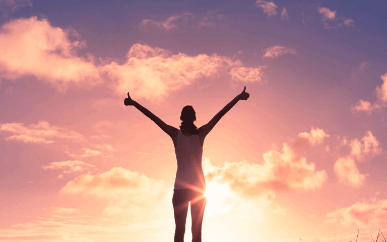 lady-with-arms-up-and-sunrise