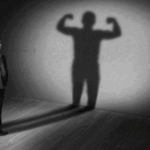 man-standing-with-his-own-shadow